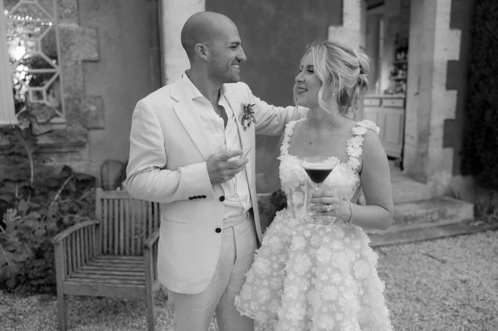 A man and woman holding drinks.  Captured by Cognac wedding photographer.