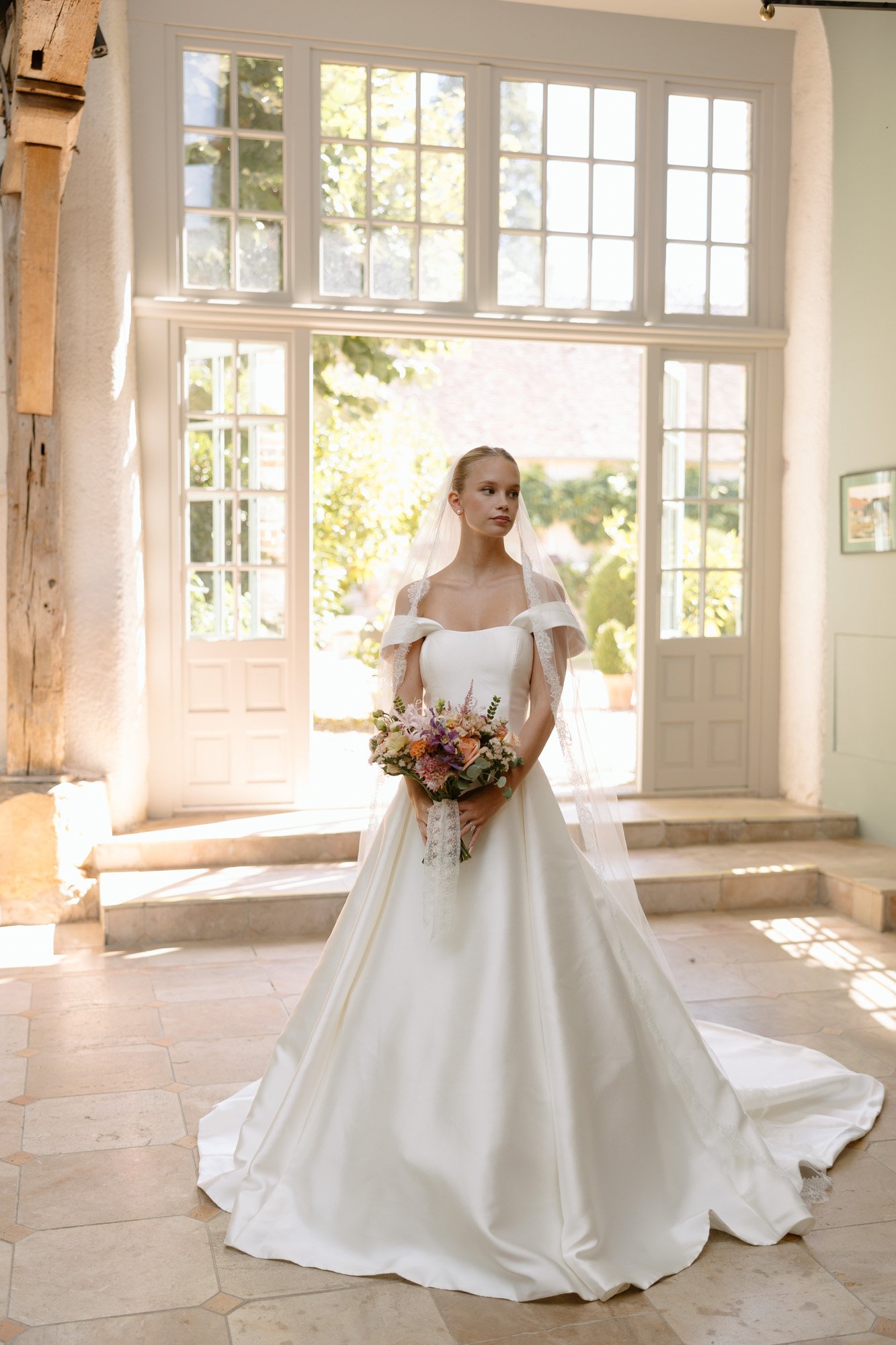 A woman in a wedding dress.  Manoir de Vacheresses wedding.