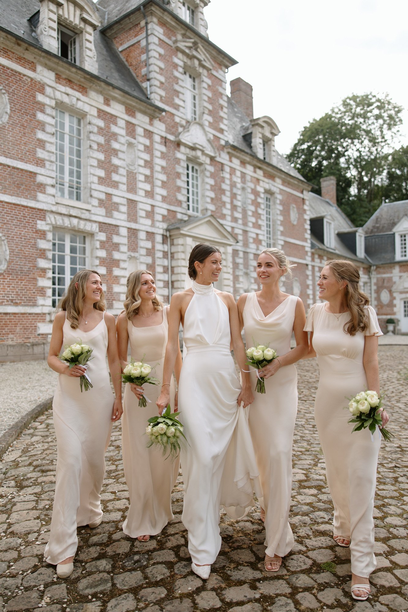 A group of women in white dresses. Captured by Northern France wedding photographer.