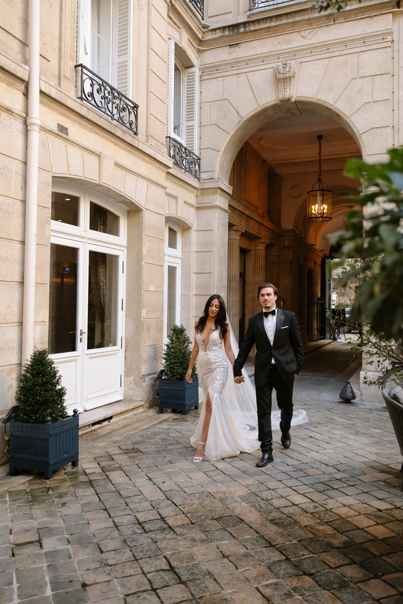 A man and woman walking down a brick walkway. Hotel Alfred Sommier Elopement.