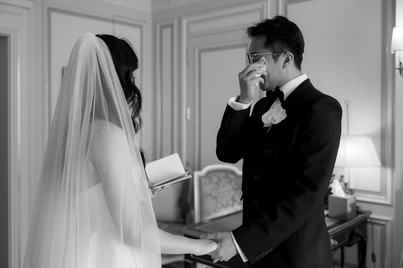 A man in a suit holding a womans hand. Intimate Ritz Paris Elopement.